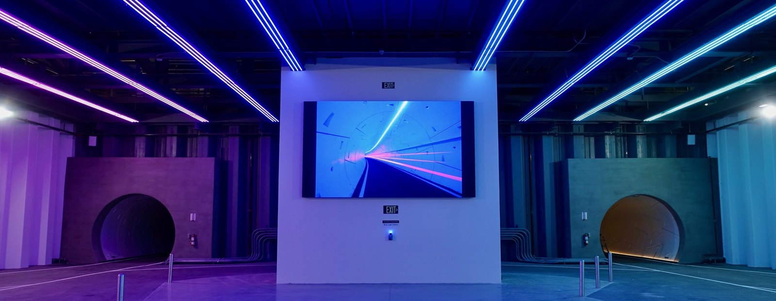 The neon-lit Vegas Loop station with twin tunnel portals